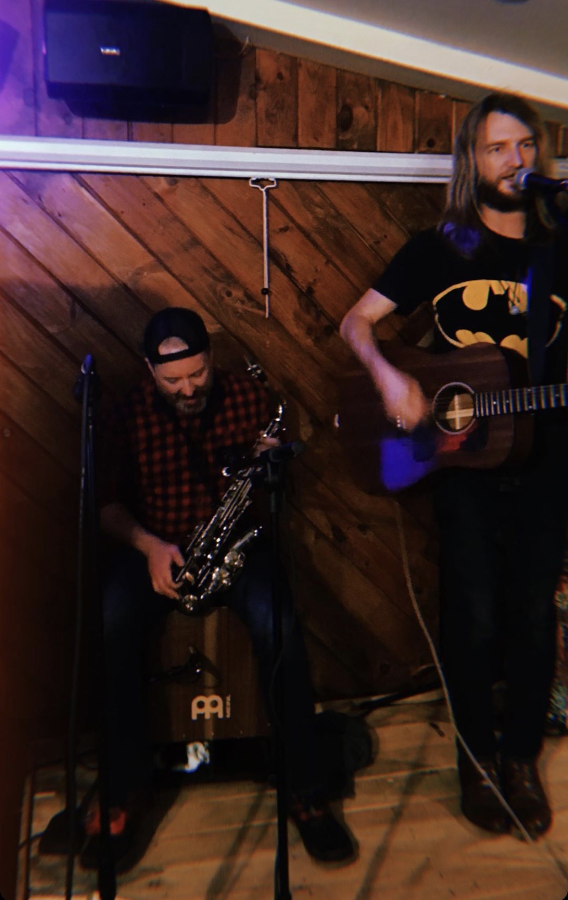 Robbie on sax next to Kristofer with guitar